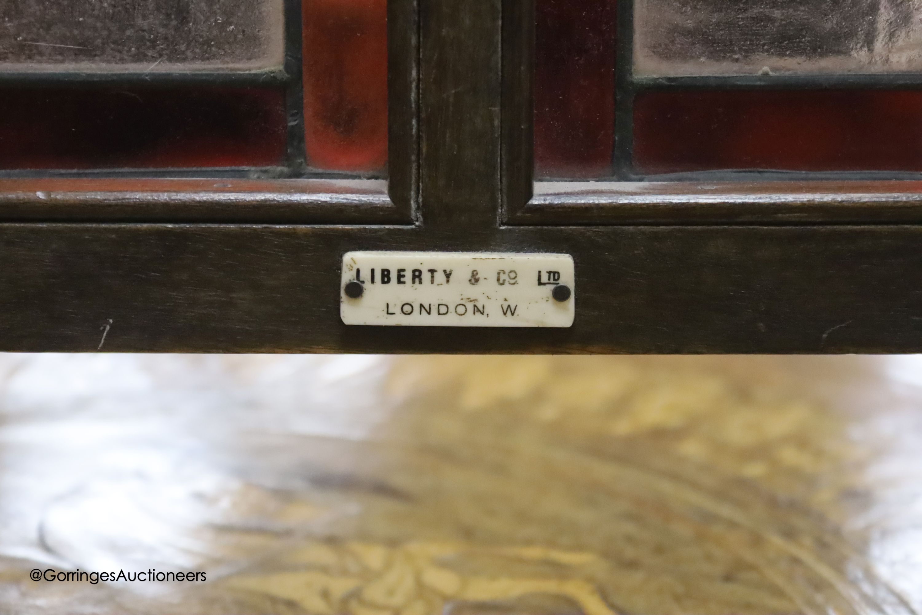 An Edwardian Liberty & Co. stained glass and beech leaded glass room screen, width 43cm, height 67cm